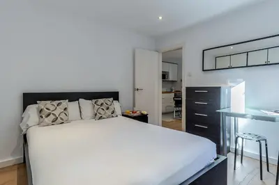 a bedroom with a large white bed and a table at 2124 - AB Poblenou Beach Comfort in Barcelona