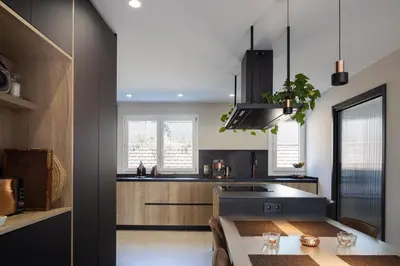 a kitchen with a sink and a table in it at Villa Beach Barcelona in Montgat