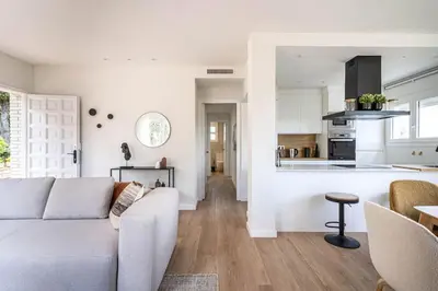 a living room with a couch and a kitchen at Vista Serena in Sant Cugat del Vallès
