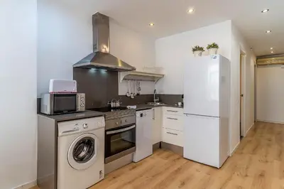 a kitchen with a refrigerator and a washer and dryer at 1774 - AB Saint Joseph Apartment in Barcelona