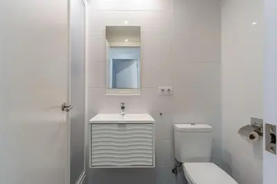a white bathroom with a sink and a toilet at 1774 - AB Saint Joseph Apartment in Barcelona