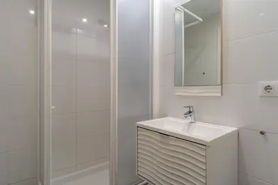 a white bathroom with a sink and a mirror at 1774 - AB Saint Joseph Apartment in Barcelona