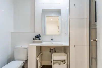 a white bathroom with a sink and a toilet at 1774 - AB Saint Joseph Apartment in Barcelona