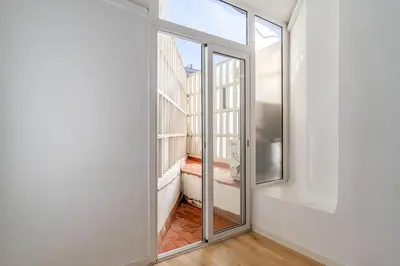 a room with a sliding glass door and a balcony at 1774 - AB Saint Joseph Apartment in Barcelona