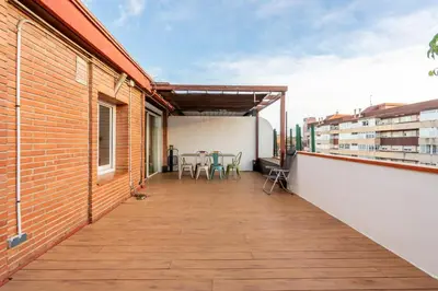 a balcony with a table and chairs on a building at Precioso Atico Vistas Montjuic in Barcelona