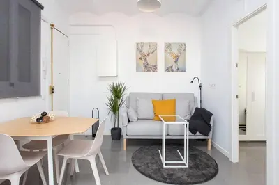 a living room with a couch and a table at Cozy And Quiet In Trendy Sants in Barcelona