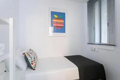 a bedroom with a bed and a picture of an apple at Relax In A Chic Apartment In Sants in Barcelona