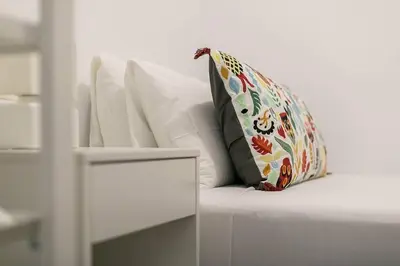 a pillow sitting on top of a white couch at Relax In A Chic Apartment In Sants in Barcelona