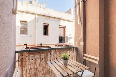 a balcony with a wooden table and a sink at Stylish Apartment In Gracia in Barcelona