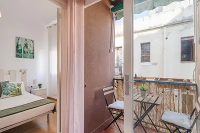 a room with a balcony with a bed and a window at Stylish Apartment In Gracia in Barcelona