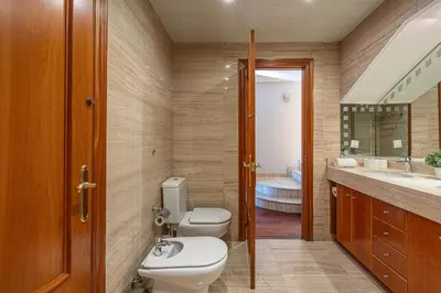 a bathroom with two toilets and a sink at Bright Attic & Amazing Terrace in Hospitalet de Llobregat
