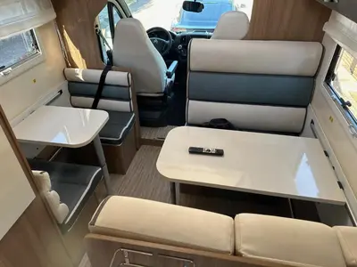an interior view of an rv with a table and chairs at Rent&Road in Caldes de Montbui