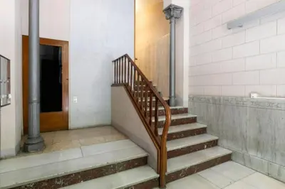 a staircase in a building with a stair case at Canela Homes BARCELONA URQUINAONA in Barcelona