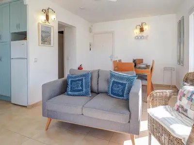 a living room with a gray couch and blue pillows at Arlene apartment by Hello Homes Sitges in Sitges