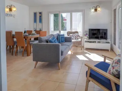 a living room with a couch and a table at Arlene apartment by Hello Homes Sitges in Sitges