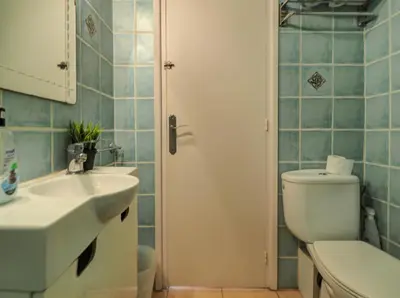 a bathroom with a white toilet and a sink at Arlene apartment by Hello Homes Sitges in Sitges