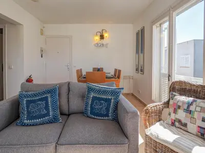 a living room with a gray couch with blue pillows at Arlene apartment by Hello Homes Sitges in Sitges