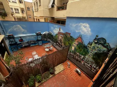 a mural on the side of a building with a patio at Barcelona Classic Gracia Apartments in Barcelona
