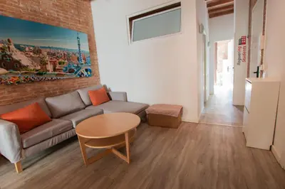 a living room with a couch and a table at Barcelona Classic Gracia Apartments in Barcelona