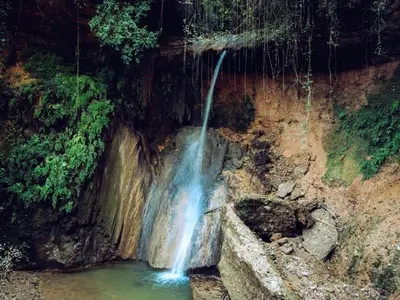 a waterfall in the middle of a pool of water at Habitación y Baño Privado, Tranquilidad y Naturaleza. in Barcelona