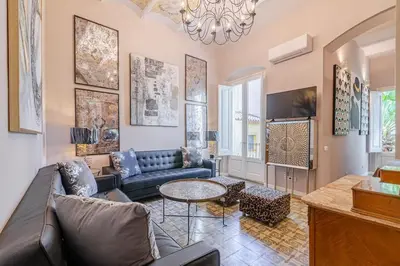 a living room with a couch and a table at Luxury villa next to the beach in Canet de Mar