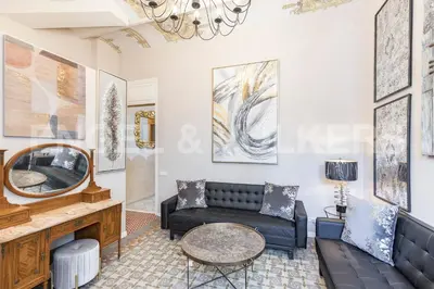 a living room with a couch and a mirror at Luxury villa next to the beach in Canet de Mar