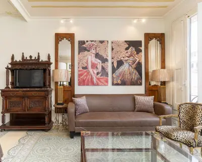 a living room with a couch and a tv at Luxury villa next to the beach in Canet de Mar