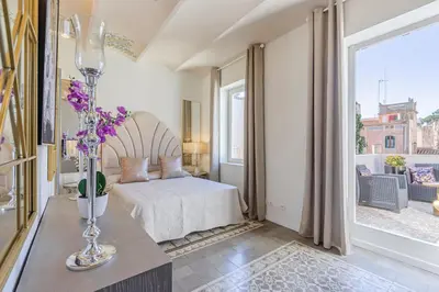 a bedroom with a bed and a large window at Luxury villa next to the beach in Canet de Mar