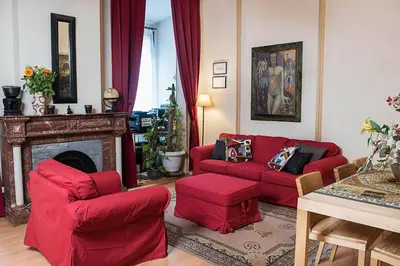a living room with red furniture and a fireplace at Fashion House in Barcelona