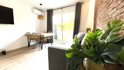 a living room with a couch and some plants at CENTRO CON TERRAZA NGRO BY PRESTIGI in Terrassa