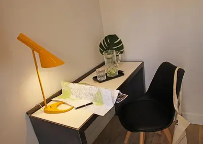 a desk with a lamp and a chair in a room at Chic & Basic Lemon Boutique Hotel in Barcelona
