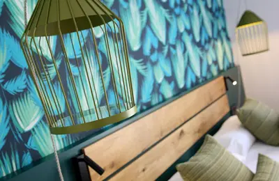 a bedroom with a bed with a bird cage on it at Chic & Basic Lemon Boutique Hotel in Barcelona