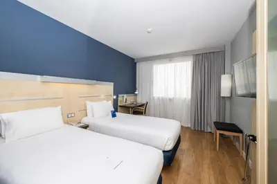a hotel room with two beds and a window at Holiday Inn Express Barcelona City 22@ by IHG in Barcelona