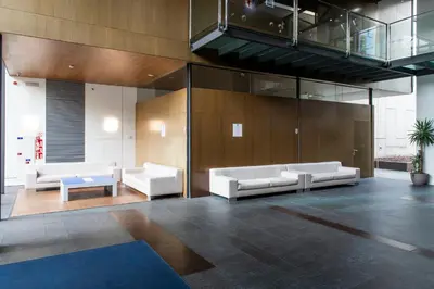 a lobby with two white couches and a table at Holiday Inn Express Barcelona City 22@ by IHG in Barcelona