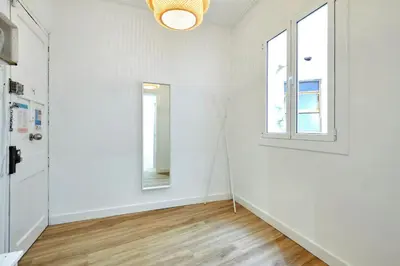 an empty room with white walls and a window at Comfortable apartment next to Apolo theater in Barcelona