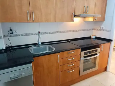 a kitchen with a sink and a stove at Apartamento a 5' de la playa in Premiá de Mar
