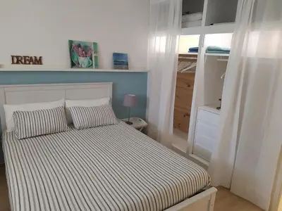 a bed with two pillows in a small bedroom at Vacaciones en Castelldefels in Castelldefels