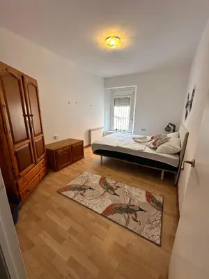 a bedroom with a bed and a rug at Vista Alegre Rest House for 7 Persons in Vallromanas