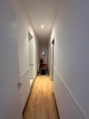 a hallway with white walls and a wooden floor at Vista Alegre Rest House for 7 Persons in Vallromanas
