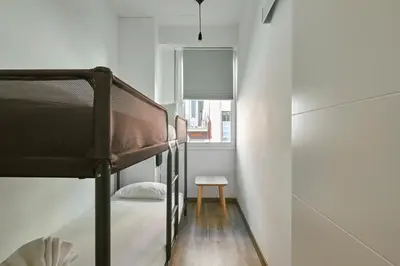 a bedroom with a bunk bed and a window at Ol Cute apartment in quiet Olivera st in Barcelona