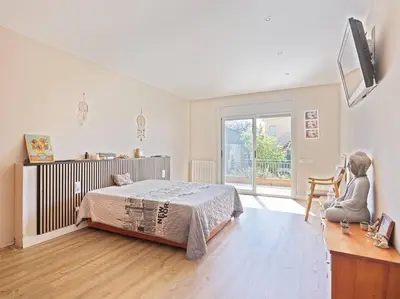 a bedroom with a bed and a desk and a window at Villa Marítima in Pineda de Mar in Pineda de Mar