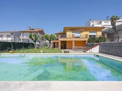 a large swimming pool in front of a house at Villa Marítima in Pineda de Mar in Pineda de Mar