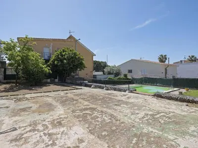 an empty parking lot in front of a house at Villa Marítima in Pineda de Mar in Pineda de Mar
