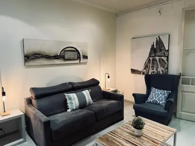 a living room with a couch and a chair at Sweet BCN Borrell in Barcelona