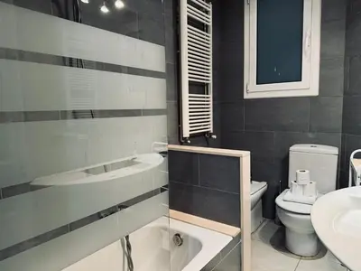 a bathroom with a sink and a toilet at Sweet BCN Borrell in Barcelona