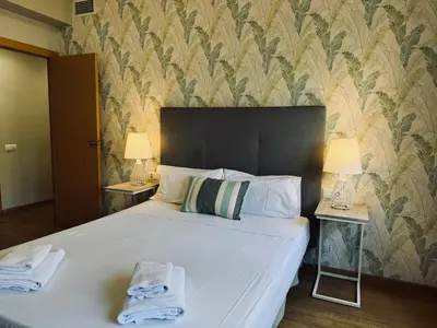 a bedroom with a large bed with towels on it at Sweet BCN Provenza in Barcelona