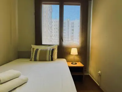 a bedroom with a white bed with a window at Sweet BCN Provenza in Barcelona
