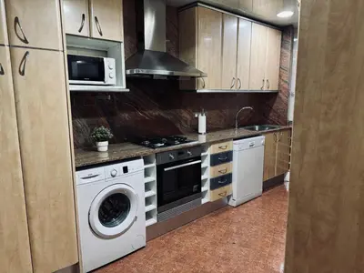a kitchen with a stove and a washing machine at Sweet BCN Provenza in Barcelona