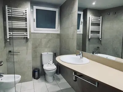 a bathroom with two sinks and a toilet and a window at Sweet BCN Provenza in Barcelona