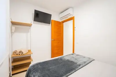 a bedroom with a bed and a tv on the wall at Home365 · Barberá del Vallés · Barcelona in Barbera del Valles